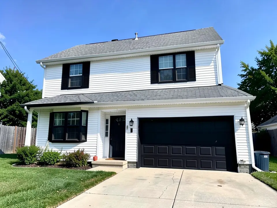 The same house with black window frames, shutters, garage door and front door; white siding and gray roof kept