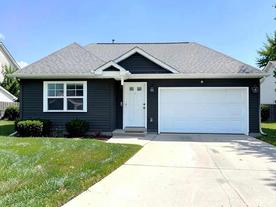The same house with dark charcoal siding; gray roof, white trim, door and garage door kept
