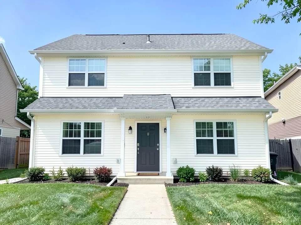 The same house with creamy white siding; gray roof, white trim and dark gray door kept