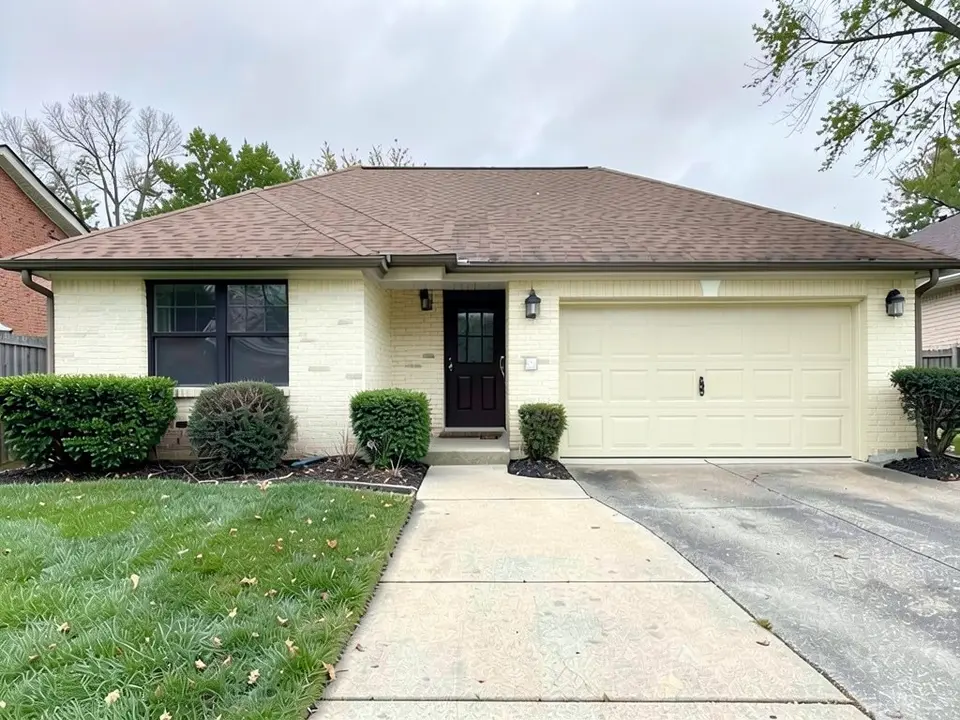 The same house with painted cream brick and a cream garage door; the roof, window frames, walkway and lawn kept