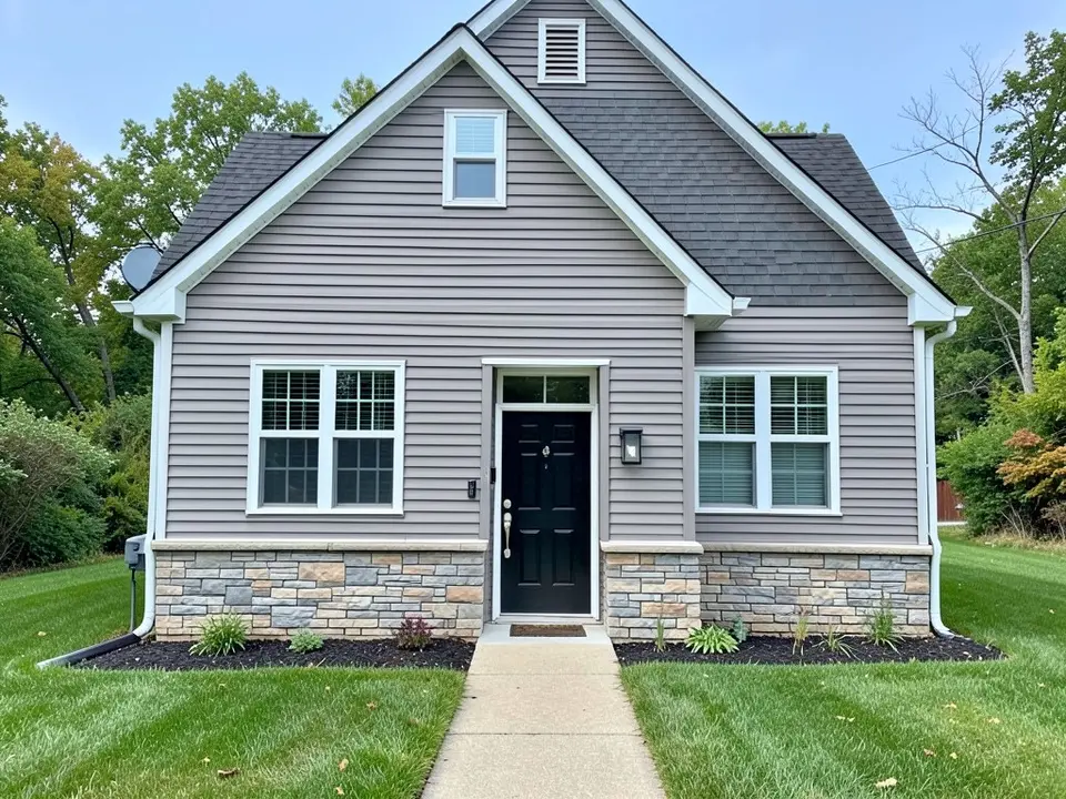 AI-drawn generic stand-in of a narrow gable-front house with gray lap siding, white trim, a stone veneer base, a black front door and a dark roof