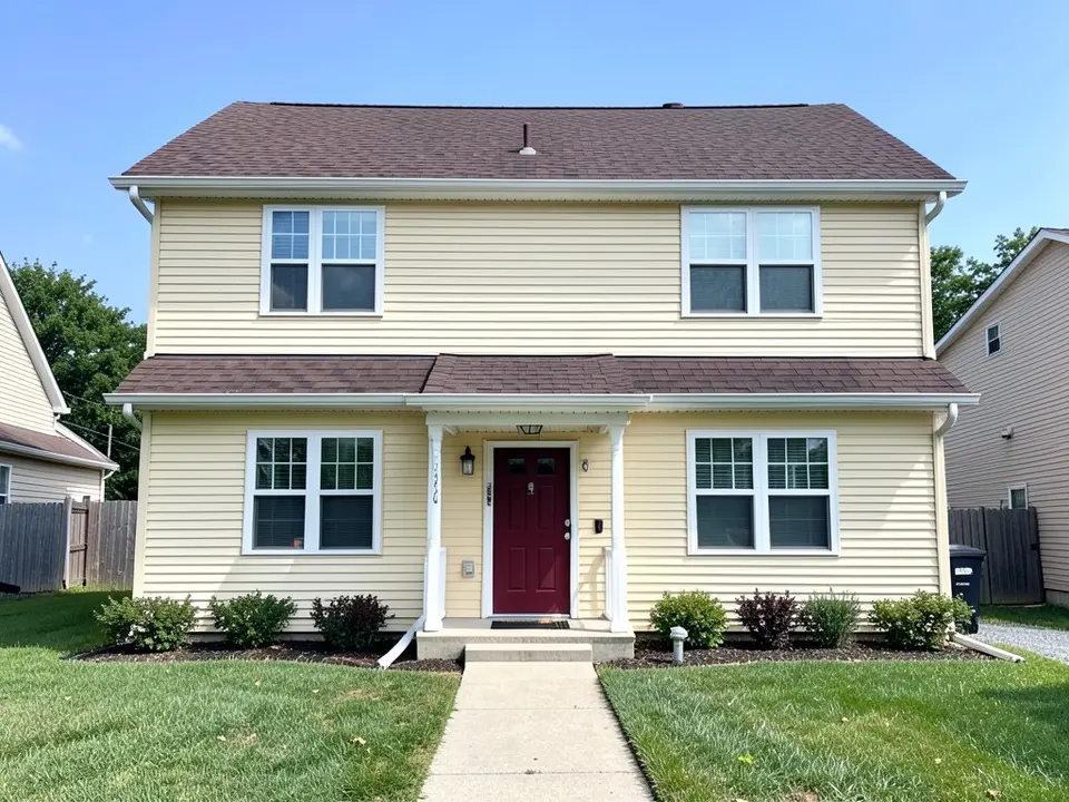 AI-drawn generic stand-in of a two-story house with pale yellow horizontal vinyl siding, white trim, a dark red front door under a small porch roof and a dark brown shingle roof