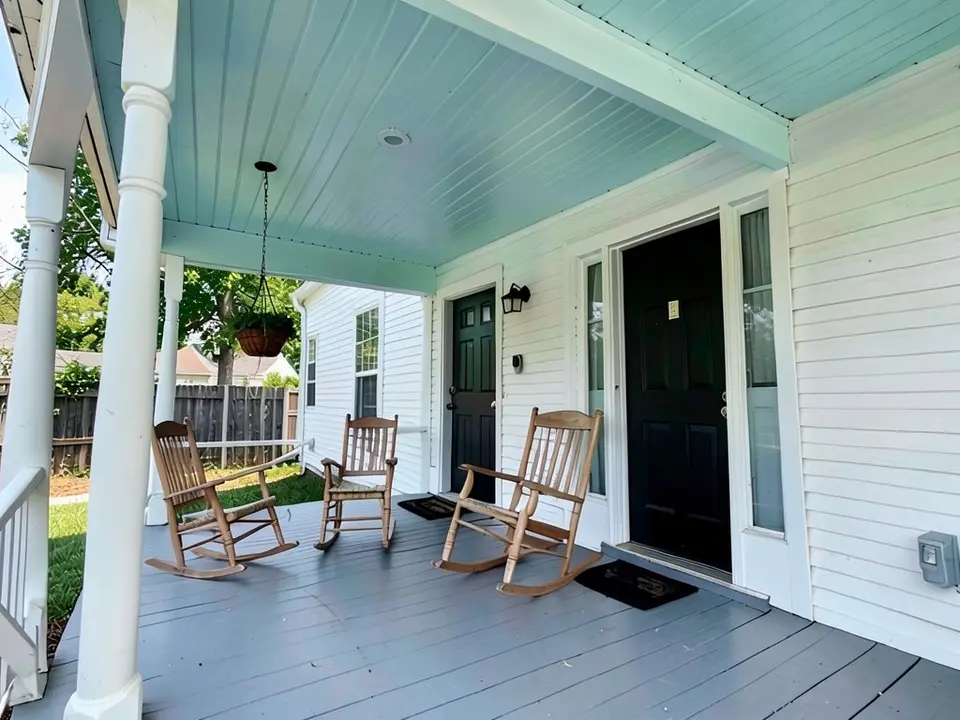 The same porch with a pale blue-green ceiling; posts, floor, chairs, door and hanging plant kept