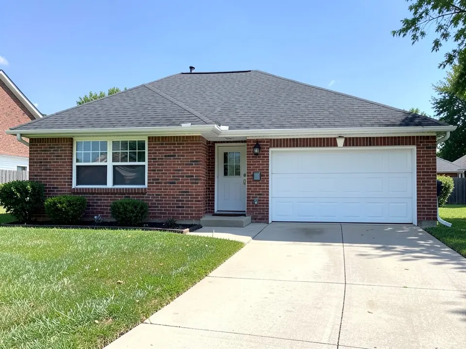 AI-drawn generic stand-in of a one-story ranch house with red brick walls, a white window, a white door, a white two-car garage door and a dark gray asphalt shingle roof