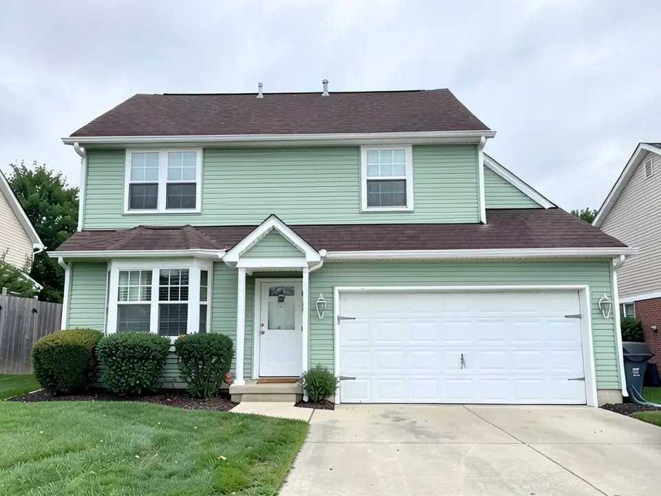 The same house with light green siding on both floors, the entry gable and the garage; white trim, white doors and dark brown roof kept