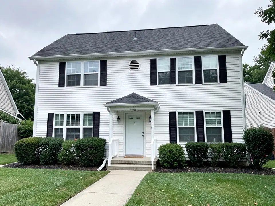 AI-drawn generic stand-in of a two-story colonial house with white horizontal vinyl siding, black shutters, white trim, a small covered stoop with a white door and a dark gray shingle roof