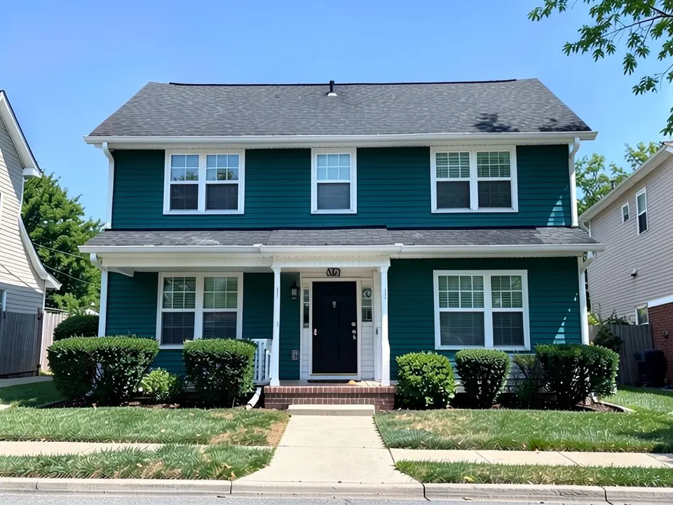 The same house with deep teal siding on both floors; white trim, black door and roof kept