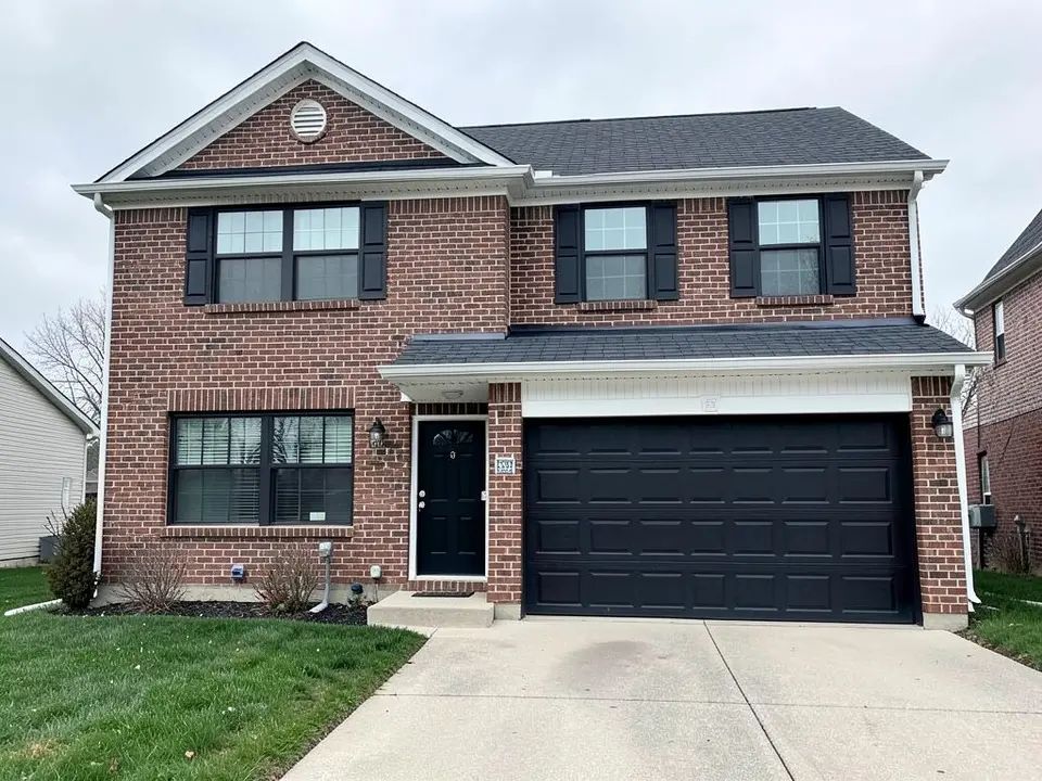 AI-drawn generic stand-in of a two-story house with red-brown brick walls, white gable and porch trim, black shutters on the upper windows, a black front door, a black garage door and a dark gray roof